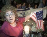 Esther Wachsman, whose son was slain by Hamas in 1994, holds a flag and candle at a solidarity rally at the US Consulate in Jerusalem yesterday.